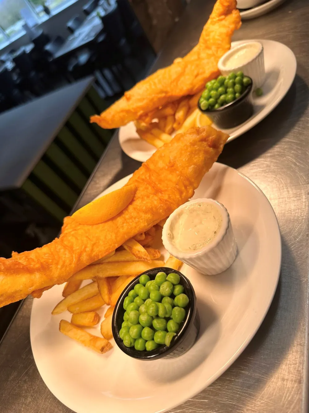 Battered fish with chips, peas and tartare sauce
