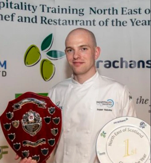 Head Chef Fraser Hobday holding the North East of Scotland Chef of the Year shield